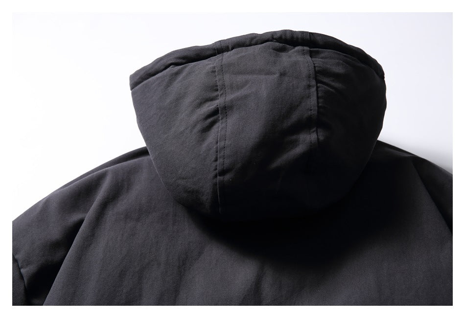 Close-up of the black jacket's hood and back seam.