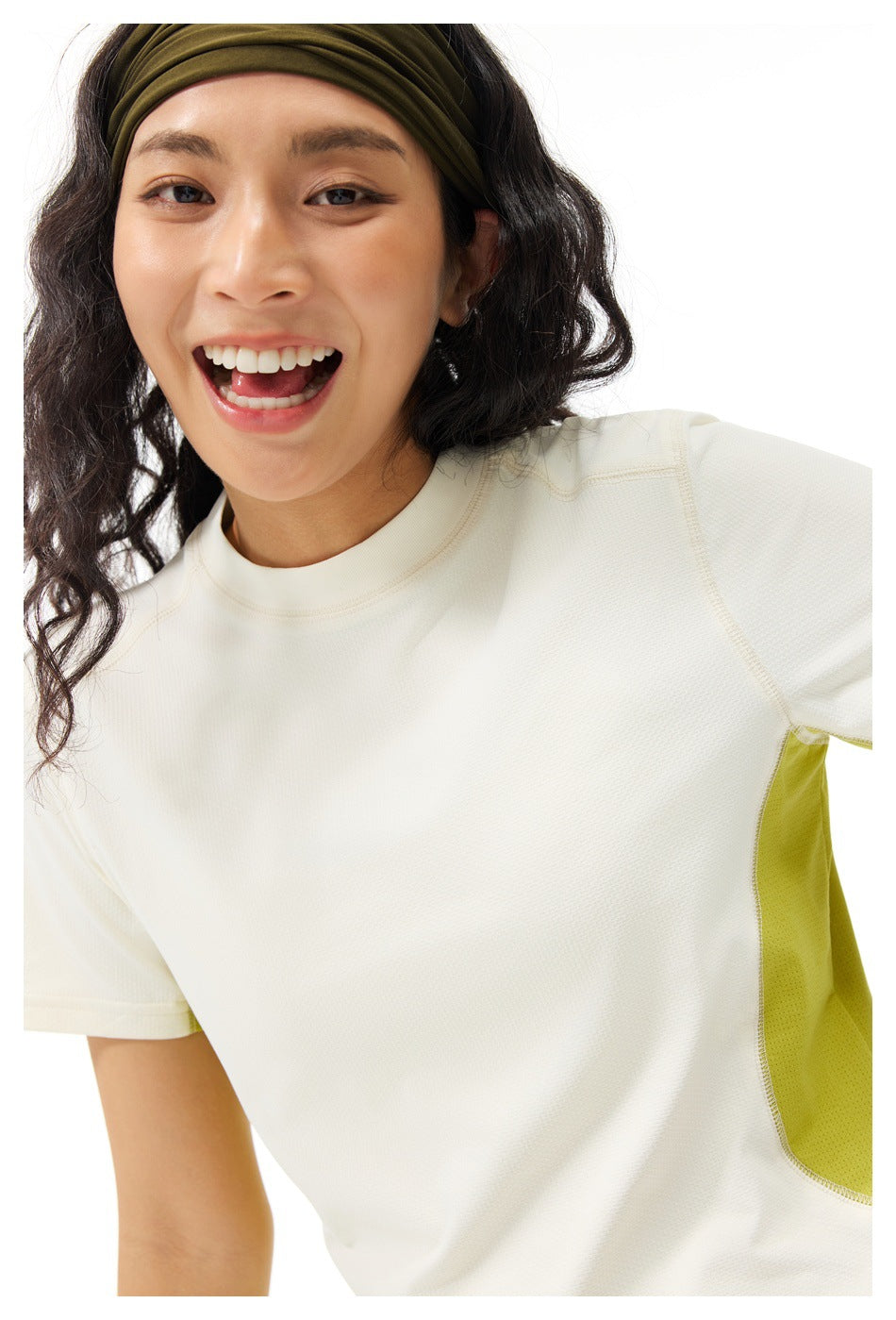 Close-up of a model wearing an ivory athletic shirt with a lime side panel.