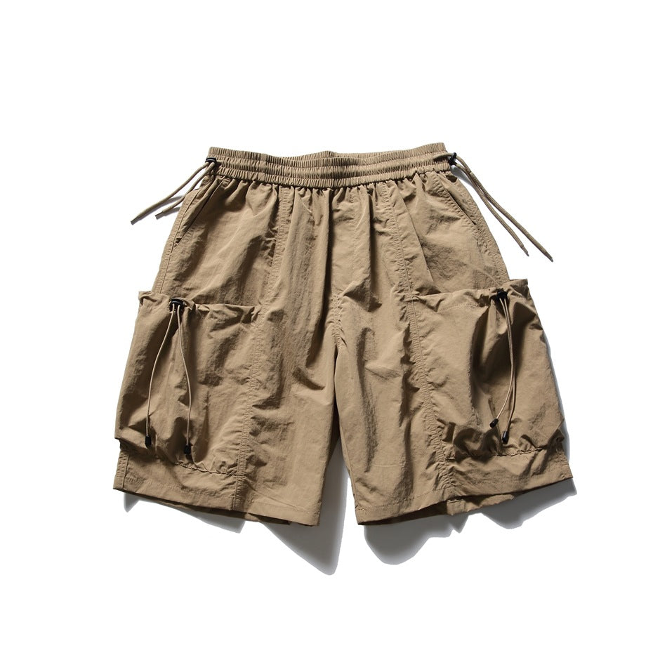 Khaki knee-length cargo shorts flat lay with drawstring waist and large side pockets with toggle cords