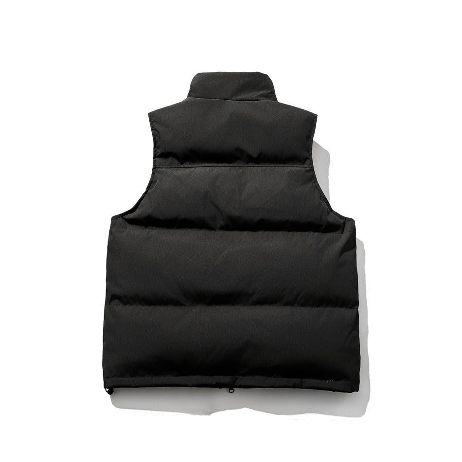 Back view of black quilted puffer vest with stand collar, horizontal channels and drawcord toggles at the hem