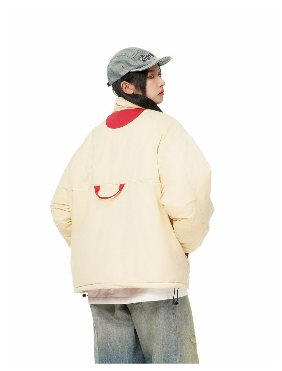 Model shown from behind wearing a cream jacket with red back accents and a light blue denim cap.