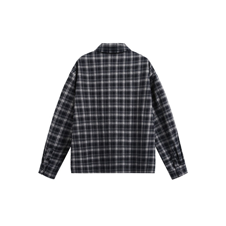 Back view of a long-sleeve black and gray plaid button-up shirt laid flat on white.