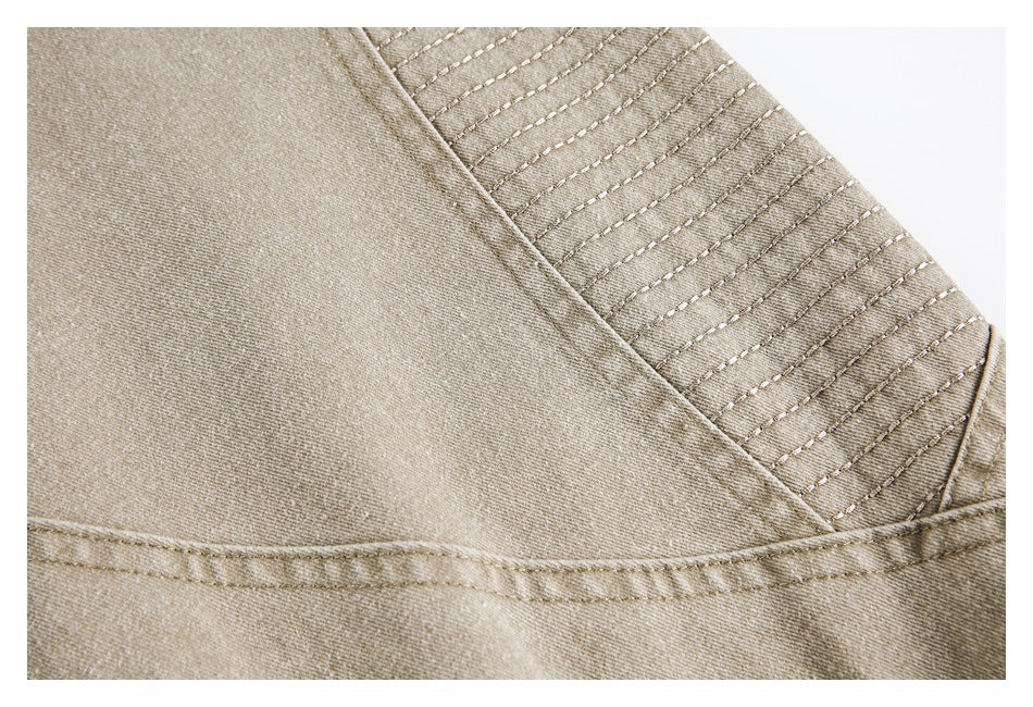 Close-up of a tan jacket panel with parallel rows of stitching and a diagonal seam.