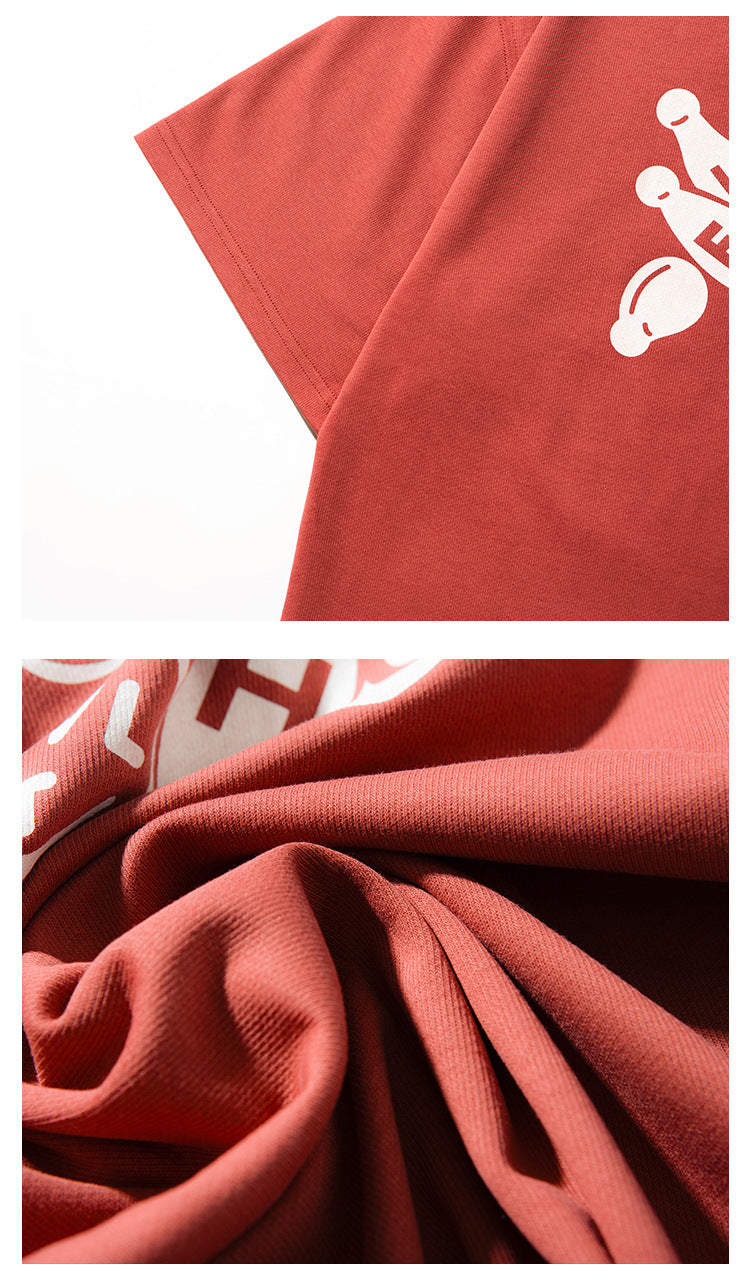 Close-up of the rust-red T-shirt's short sleeve, stitching and gathered fabric.