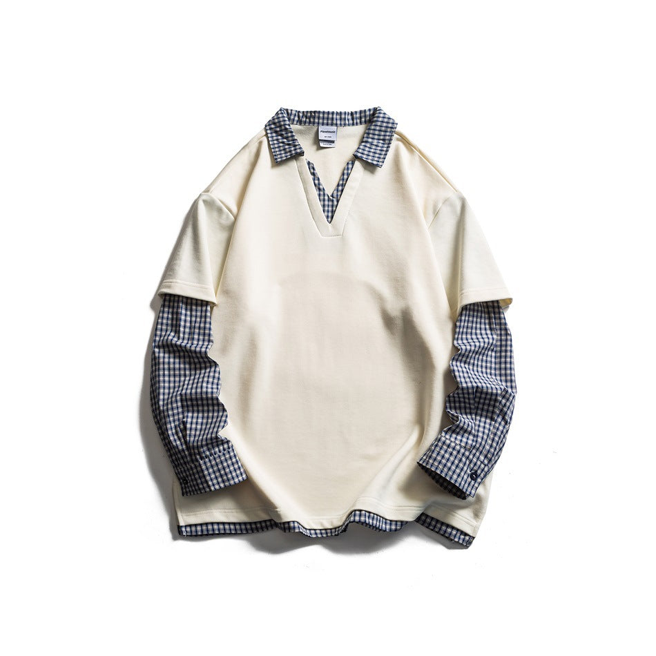 Off-white faux two-piece V-neck top with navy plaid collar, long sleeves and hem trim, flat lay