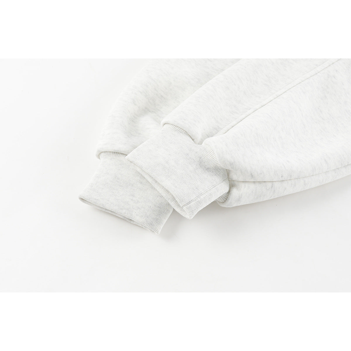 Close-up of the light gray sweatshirt's long sleeve and ribbed cuff.