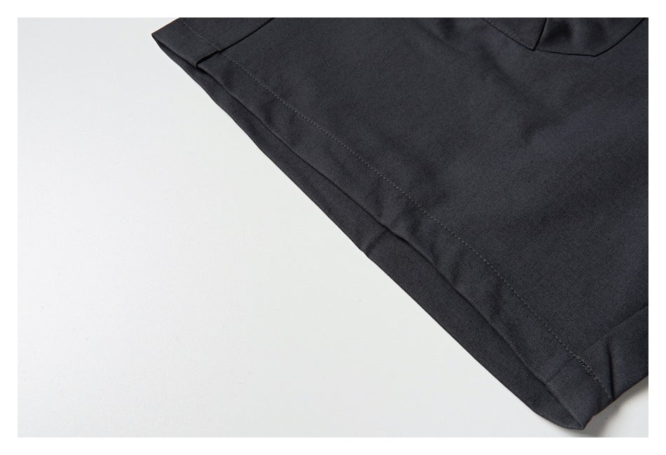 Close-up of the charcoal trouser leg hem with visible stitching and part of a rear pocket.