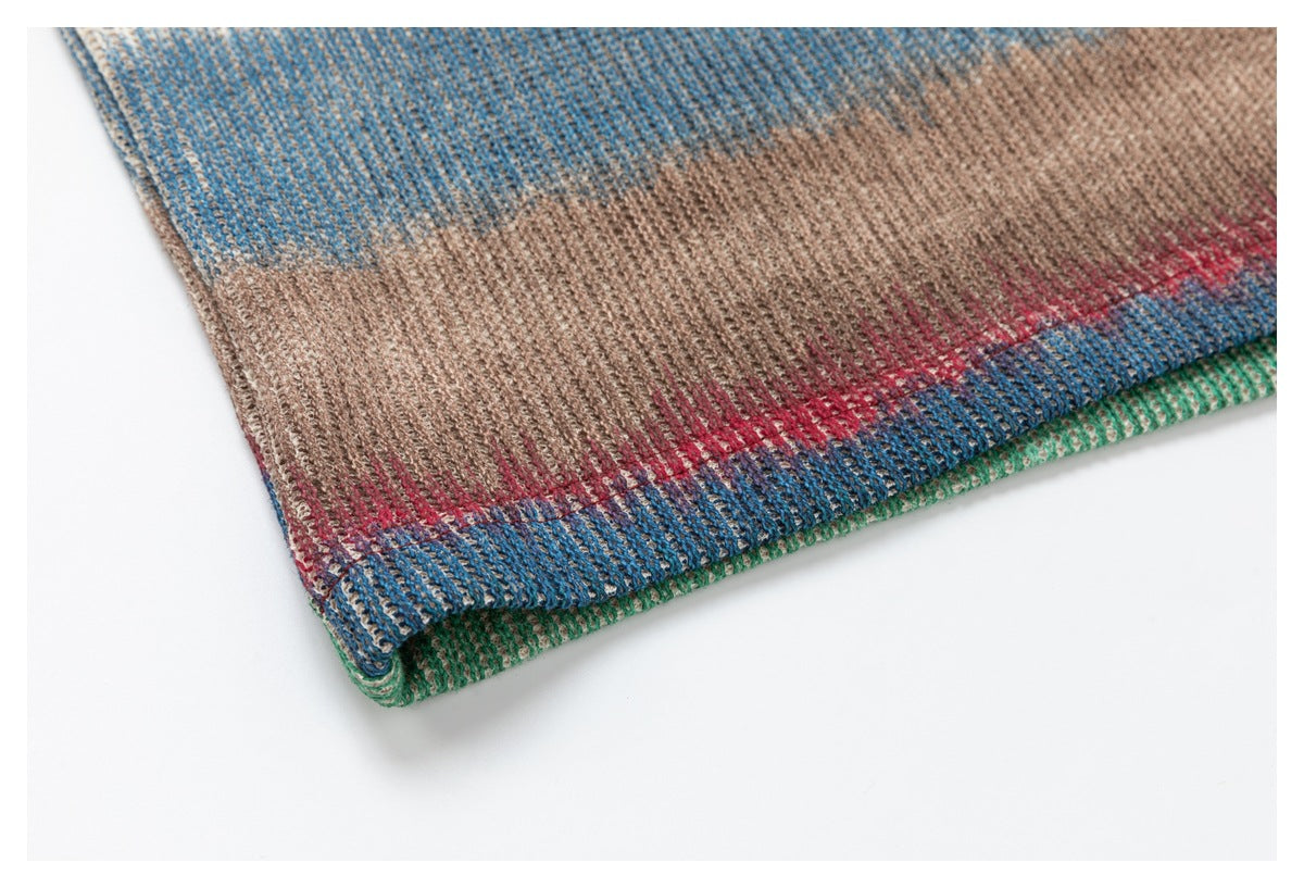 Close-up of the multicolored knit top's folded hem with blue, red, tan, and green bands.