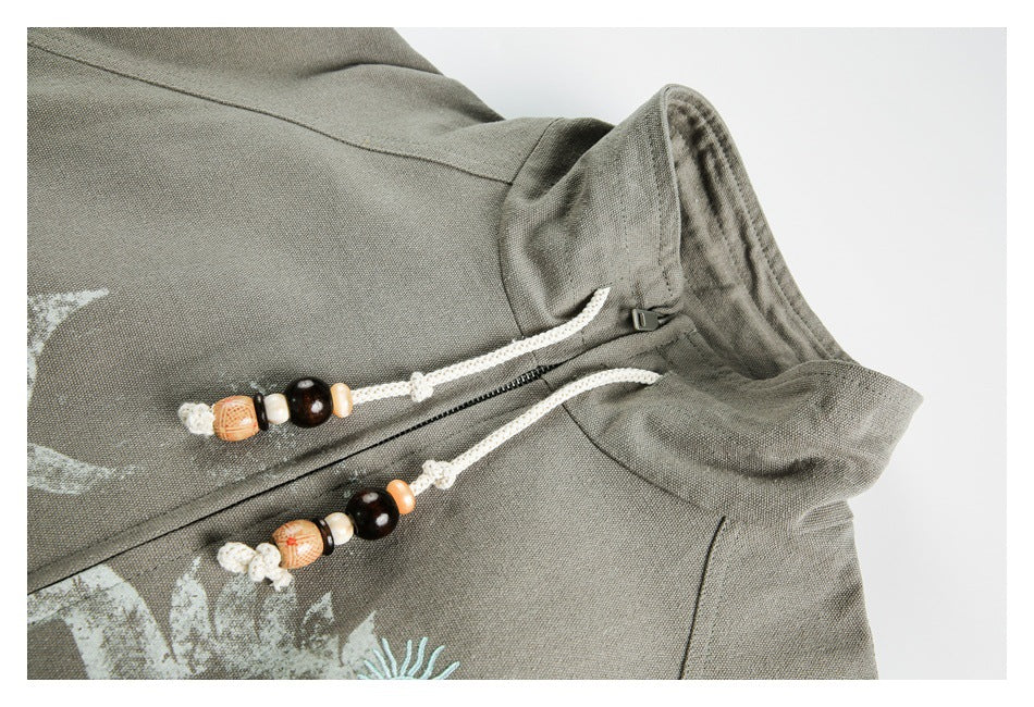 Close-up of the jacket collar, zipper, and cream cord pulls with decorative beads.