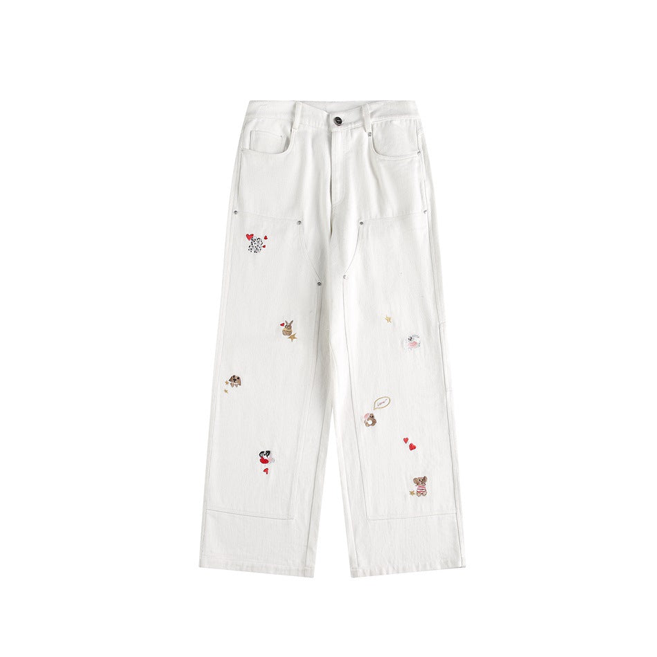 White wide-leg carpenter pants with small embroidered animals, hearts and stars, flat front view