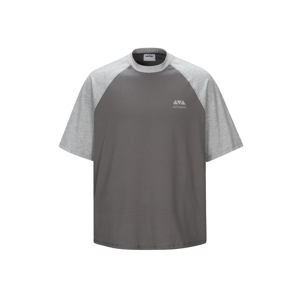 Front of a dark gray T-shirt with light heather gray raglan sleeves and a small chest logo on a white background