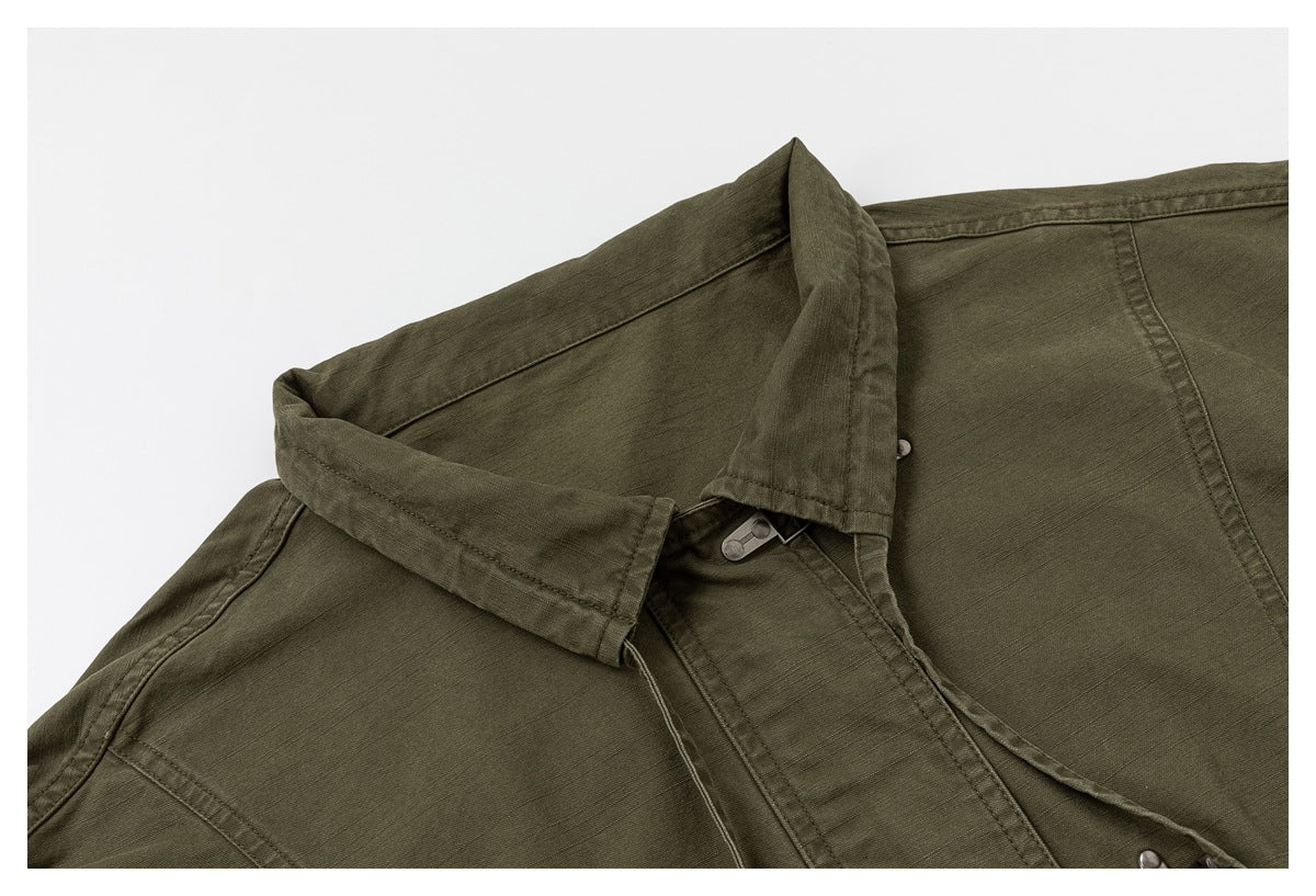 Close-up of the olive jacket's collar and layered front placket with a partly visible metal closure.