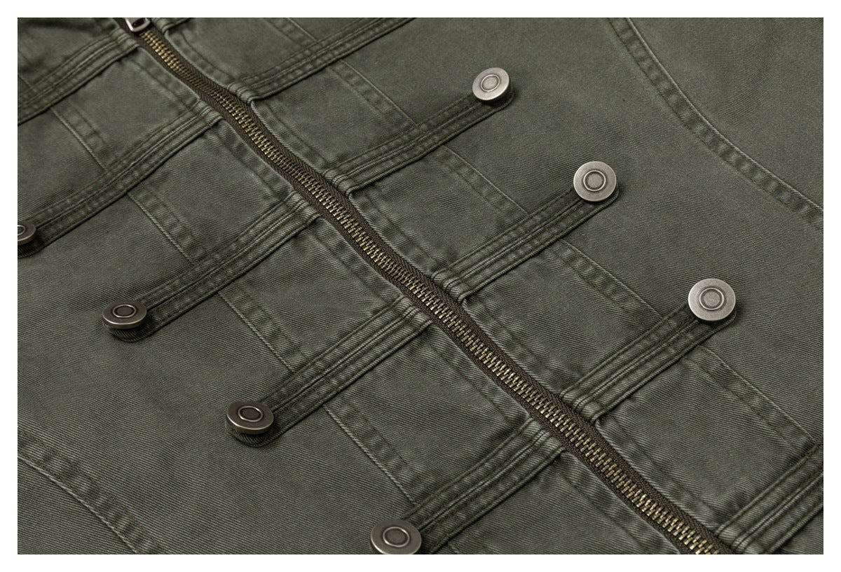 Close-up of an olive-gray jacket front with a diagonal zipper and rows of stitched button tabs.