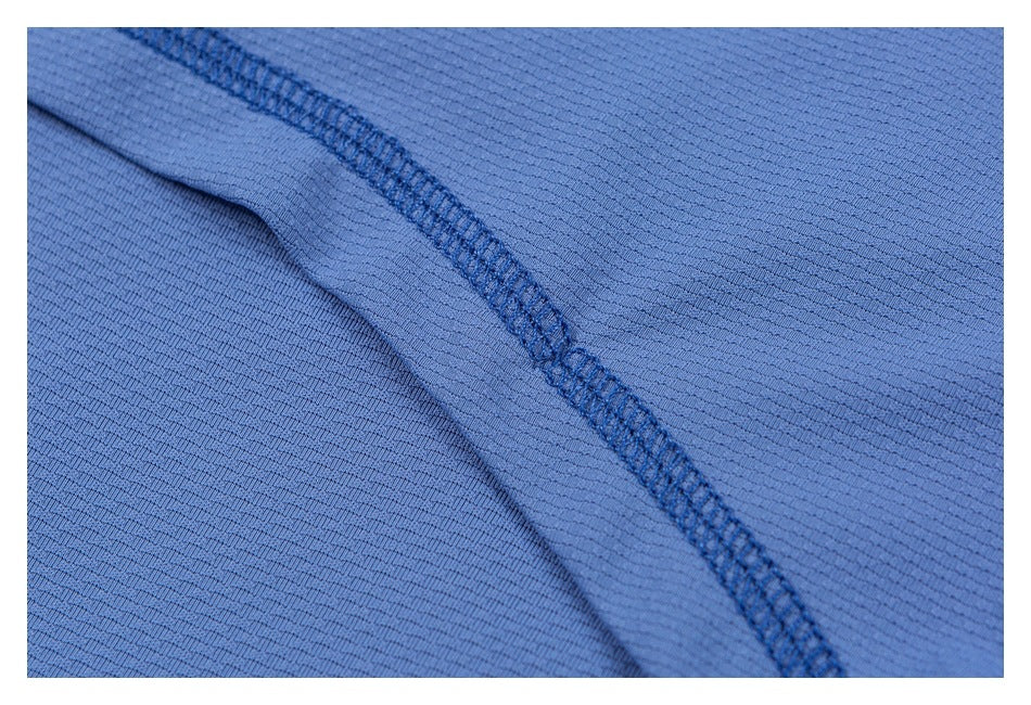 Close-up of a reinforced seam on textured blue garment fabric.