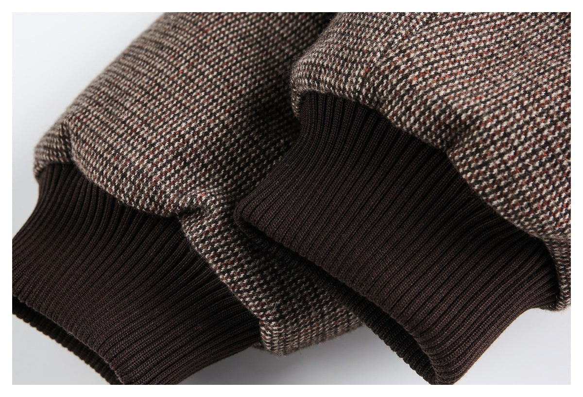 Close-up of brown, cream, and rust tweed fabric with dark brown ribbed cuffs.