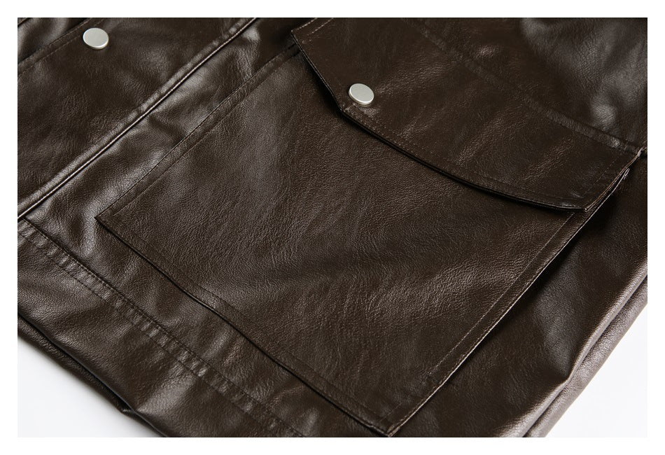Close-up of a large dark brown jacket pocket with a curved snap-button flap.