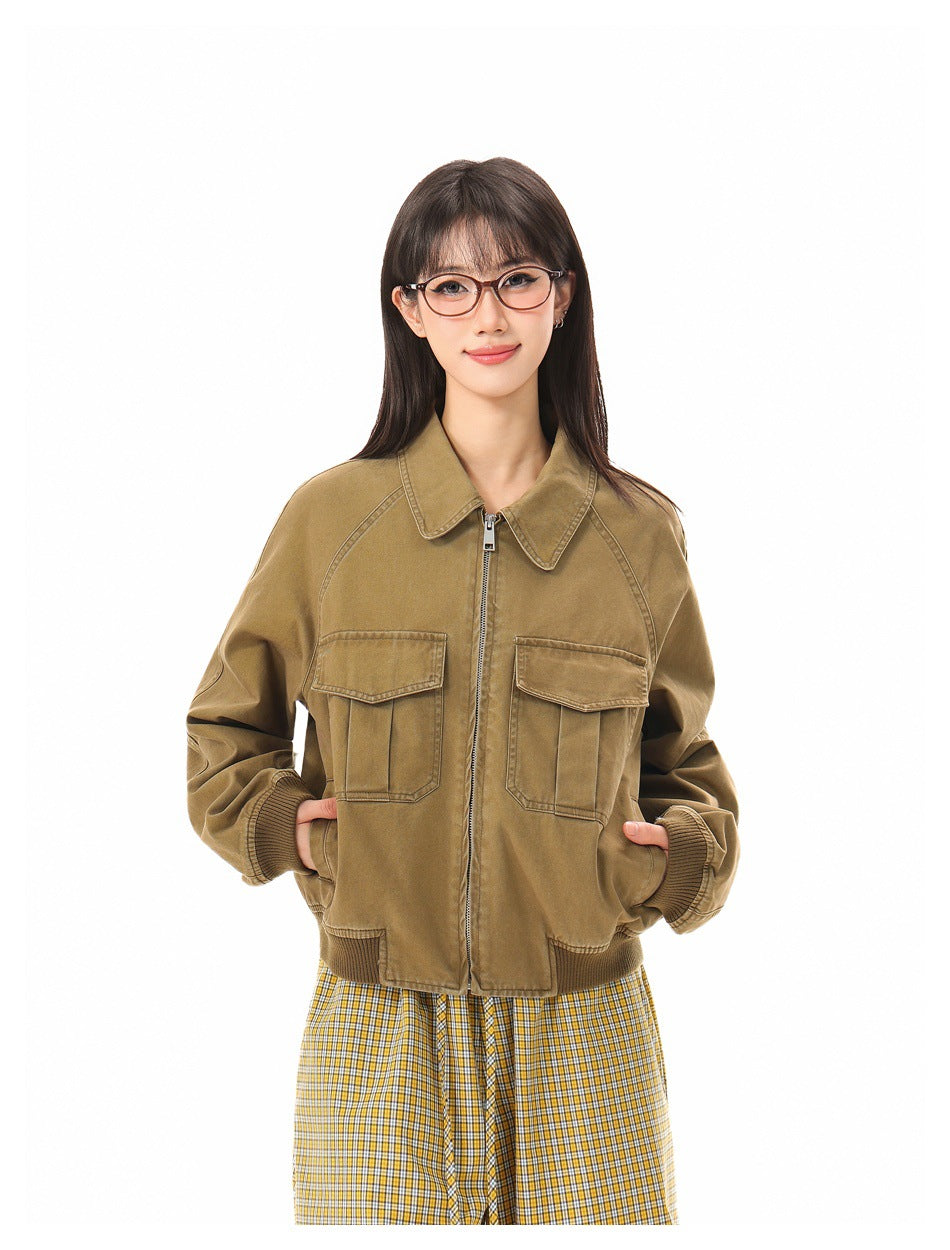 Front view of a model wearing a zipped tan utility jacket with two flap chest pockets and ribbed trim.