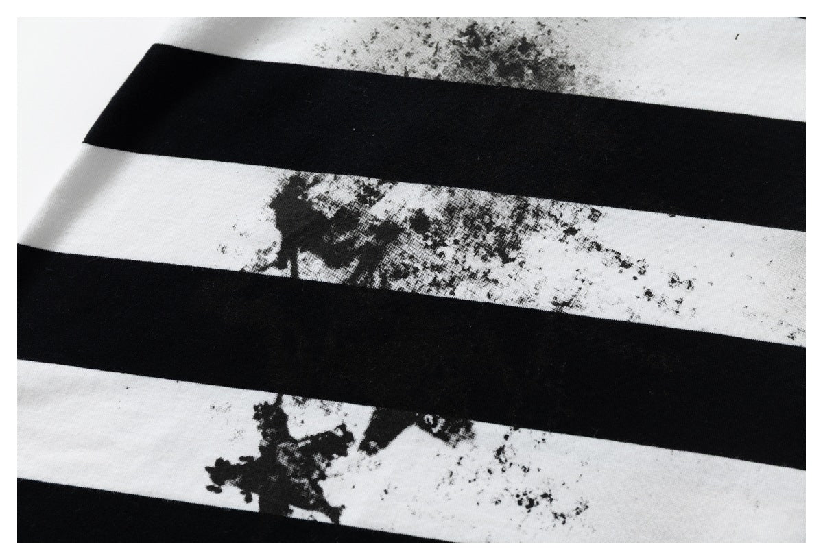 Close-up of alternating black and white stripes with distressed black print on the white bands.
