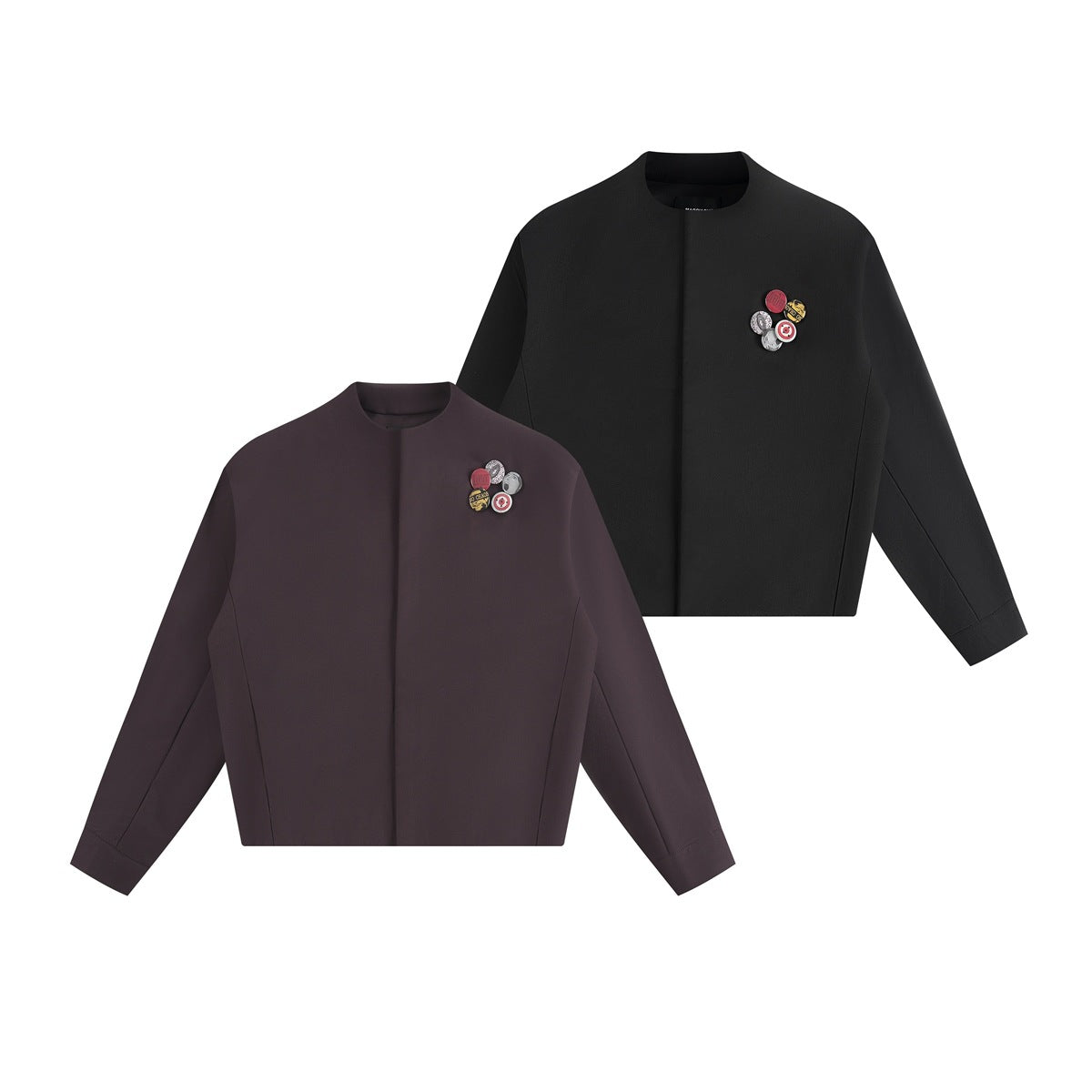 Front views of the cropped, collarless jacket in dark plum and black, each with decorative chest pins.