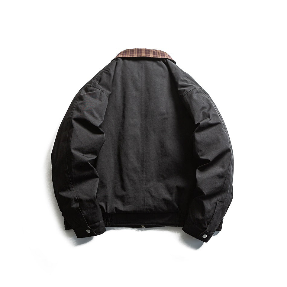 Back view of a black jacket with a plaid collar, long sleeves, and an elastic hem.