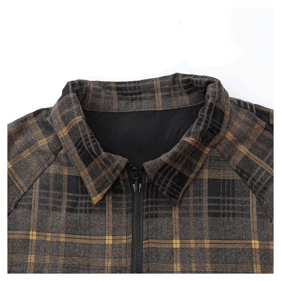 Close-up of the plaid jacket's pointed collar, black front zipper, and upper lining.