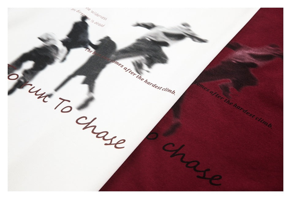 Close-up of white and burgundy garments with a dark blurred-figure graphic and reddish English lettering.
