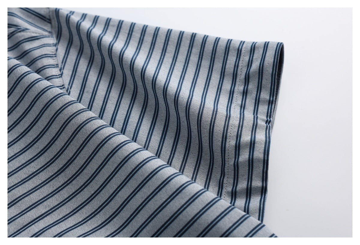 Close-up of the gray-blue top’s narrow navy stripes and stitched sleeve edge.