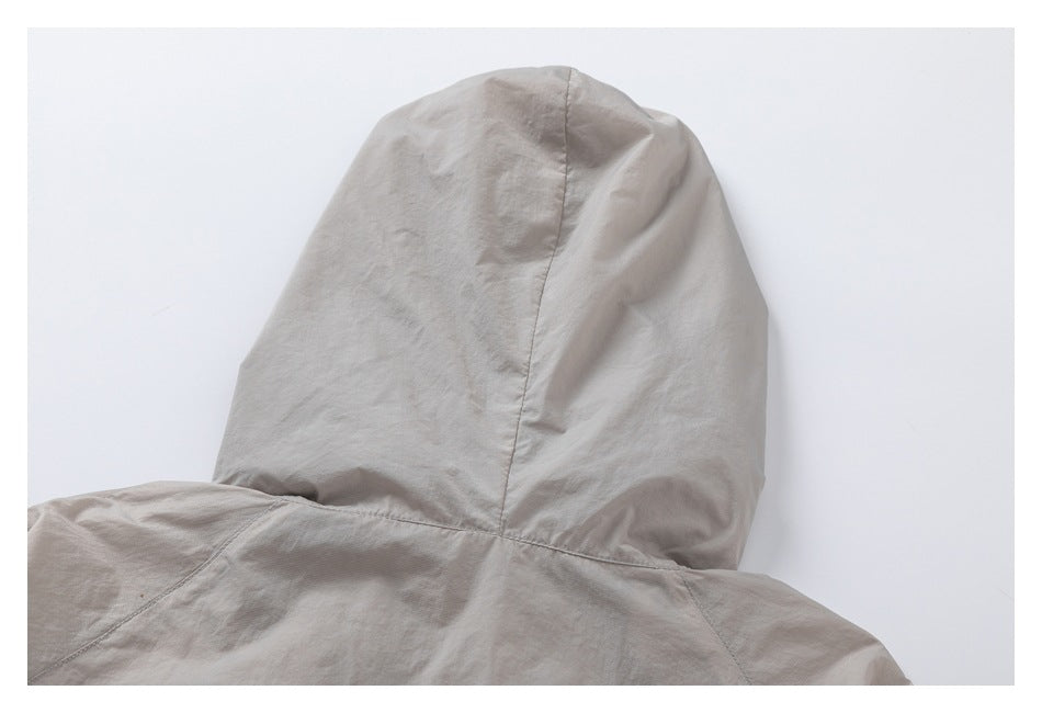 Rear close-up of a taupe garment hood and its stitched seams.