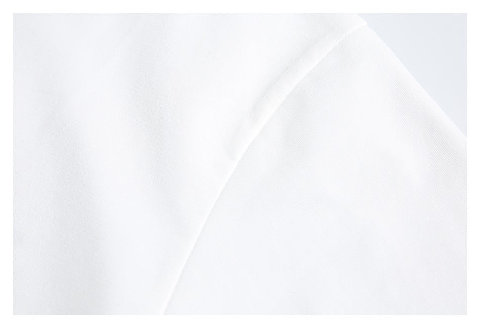 Close-up of a white shirt's shoulder seam and sleeve.