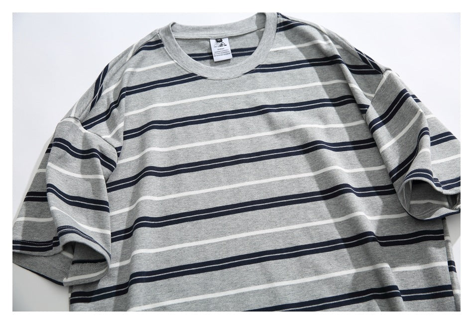 Flat-lay front of a gray short-sleeve crewneck T-shirt with navy and white horizontal stripes.