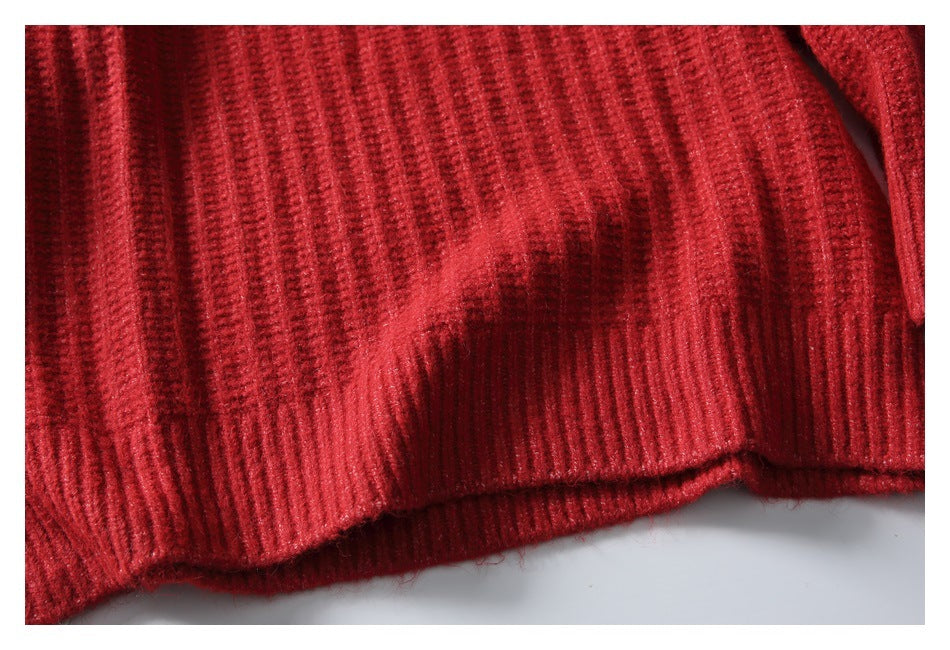 Close-up of the red knit garment's ribbed bottom hem.