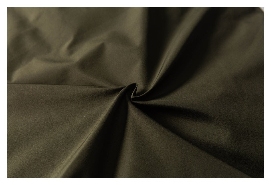 Close-up of olive fabric gathered into soft folds.