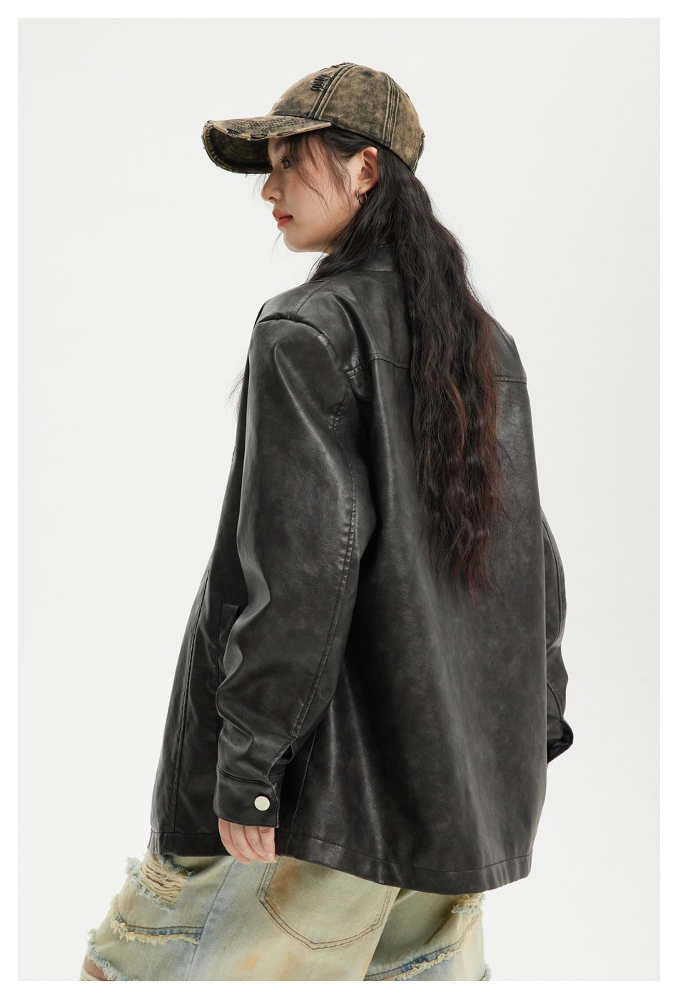 Side and rear view of a model wearing a charcoal-black jacket with a plain back and cuff button.