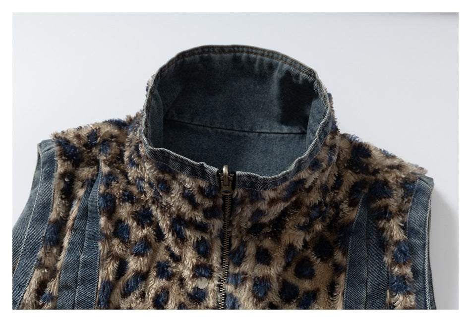 Close-up of a denim jacket with a high collar, front zipper, and tan-and-navy spotted plush panels.