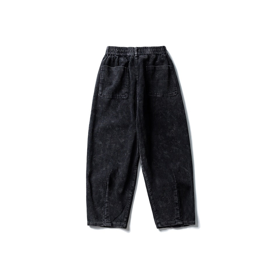Back view of washed black corduroy wide-leg pants with elastic waistband and two patch pockets