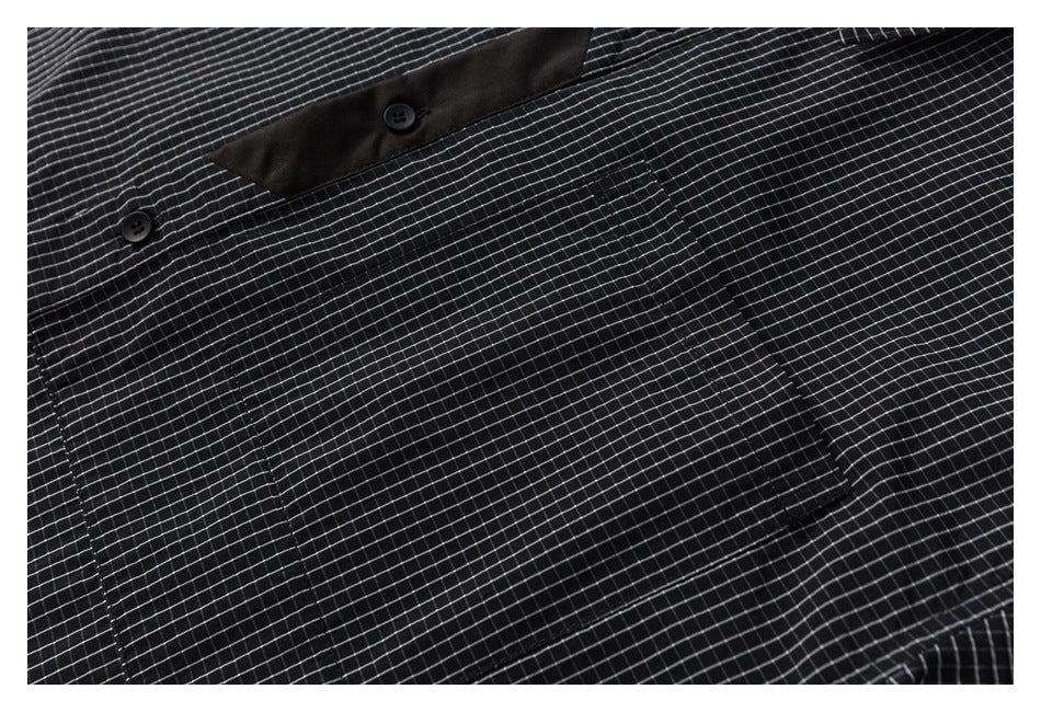 Close-up of the shirt's rectangular chest pocket and fine-grid pattern.