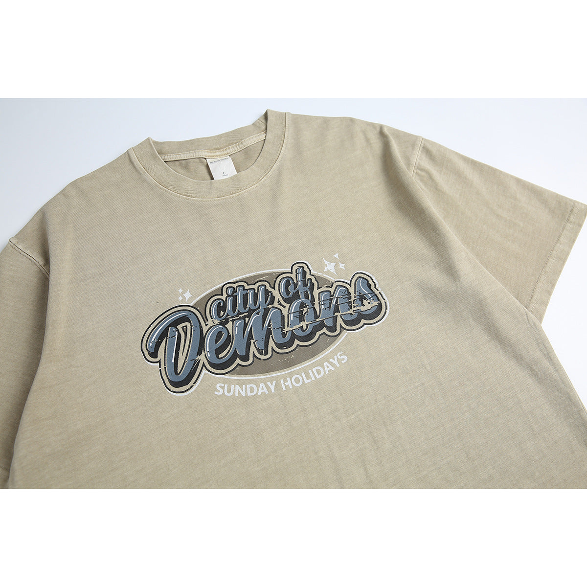 Front of a beige short-sleeve T-shirt with a large layered graphic reading “City of Venice” and “Sunday Holidays.”