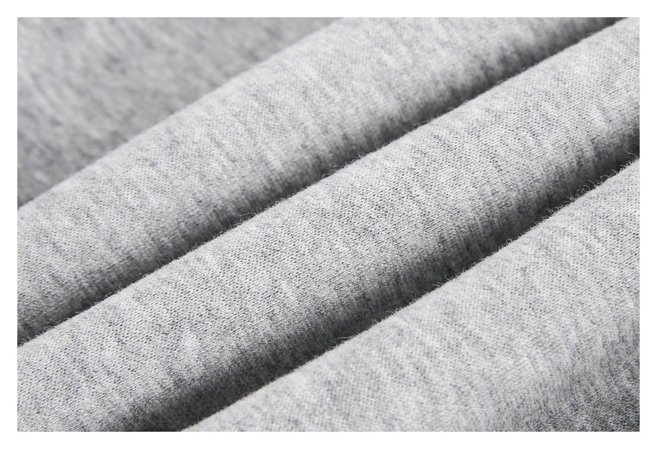Macro view of the heather-gray sweatshirt fabric and its textured knit surface.
