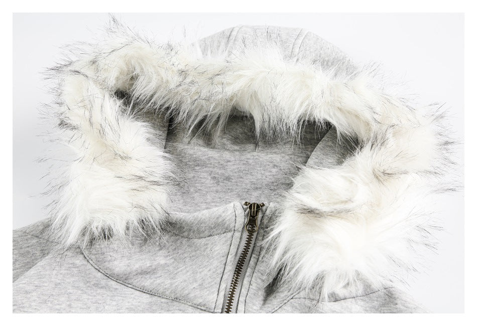Close-up of a light gray jacket hood trimmed with long white faux fur.