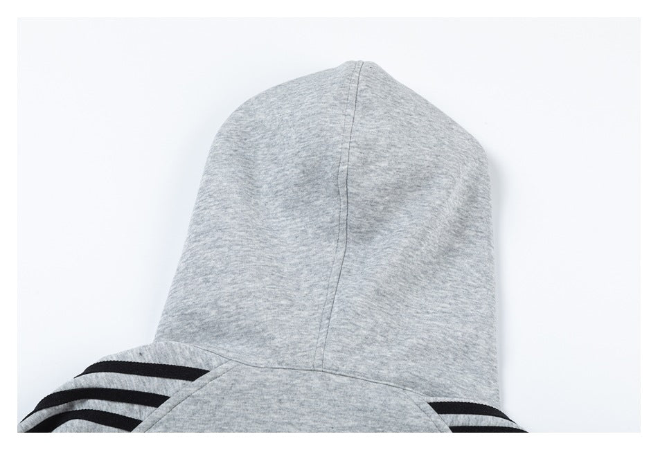 Rear close-up of a heather gray hood with black stripes visible across the shoulders.
