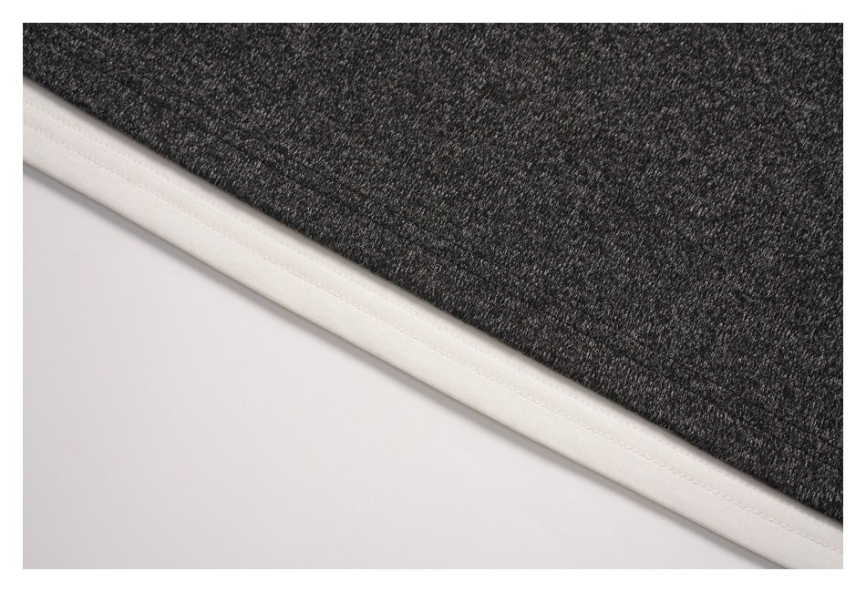 Close-up of the charcoal heather outer layer and white fabric visible along the hem.