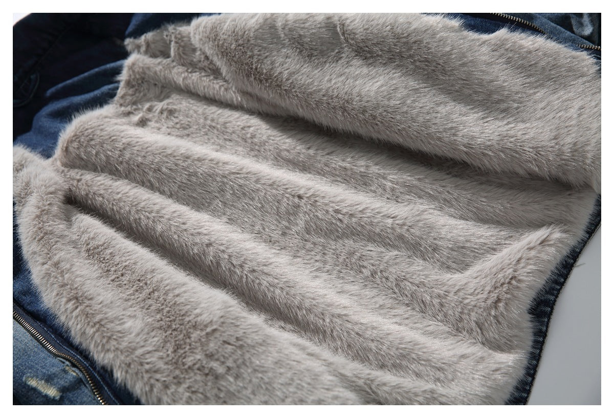 Close-up of the light gray plush lining spread across the inside of a denim jacket.