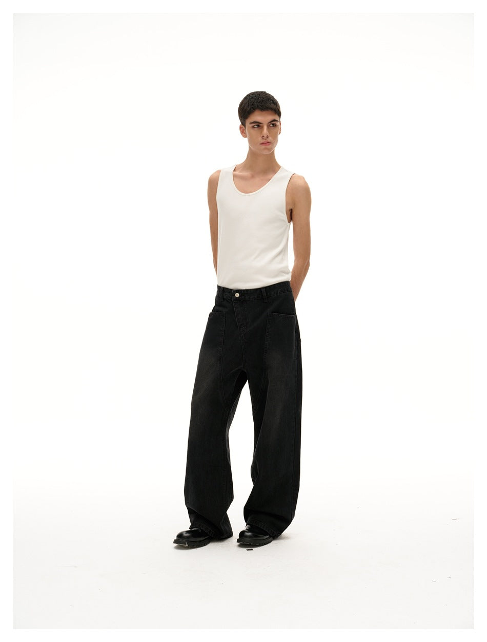 Model wearing a white tank top and black, extra-wide-leg jeans against a plain white background.