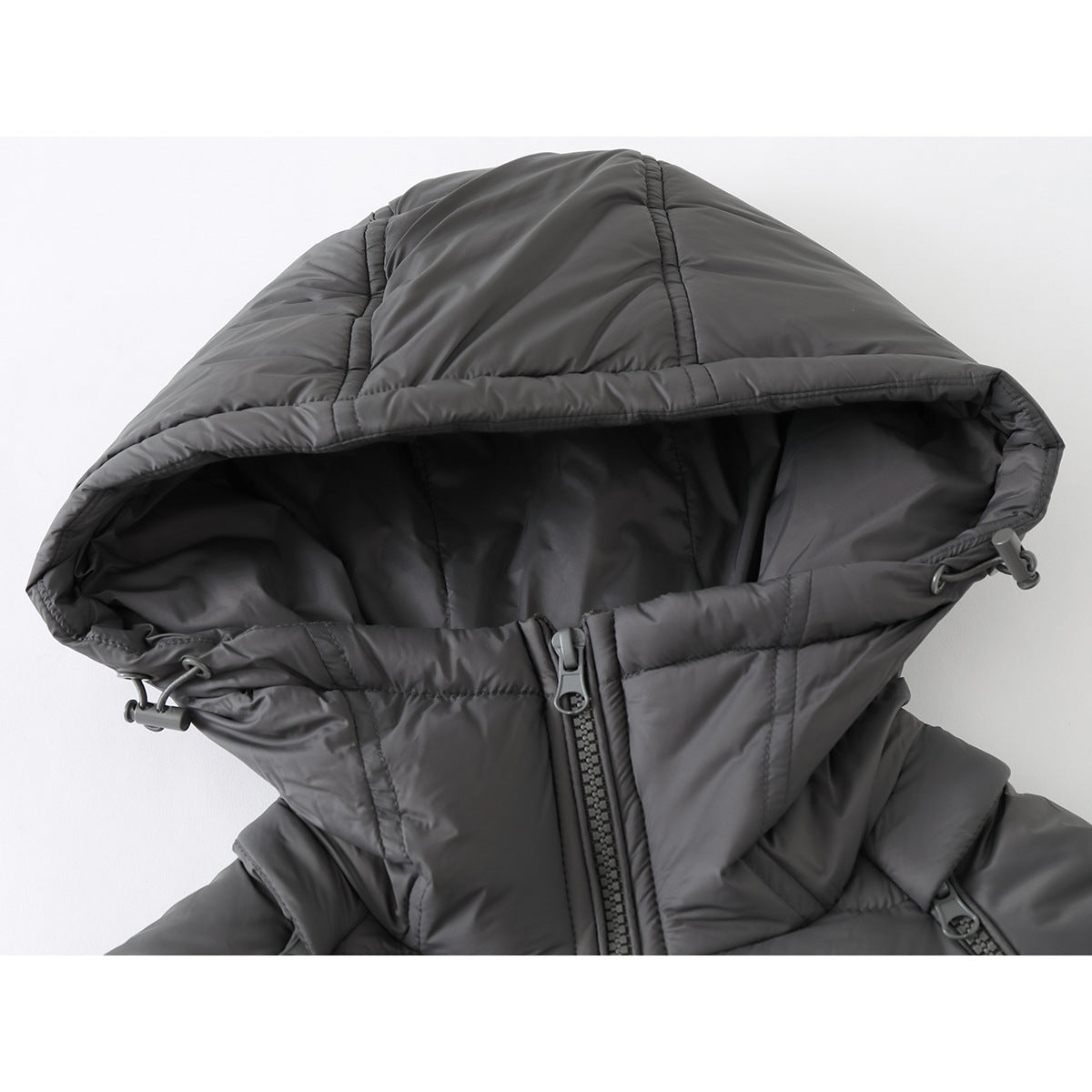 Close-up of a charcoal-gray padded jacket hood, drawcords, and front zipper.