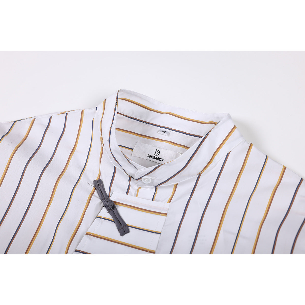 Close-up of a white striped shirt's band collar and gray frog closure; a black brand label is visible inside.