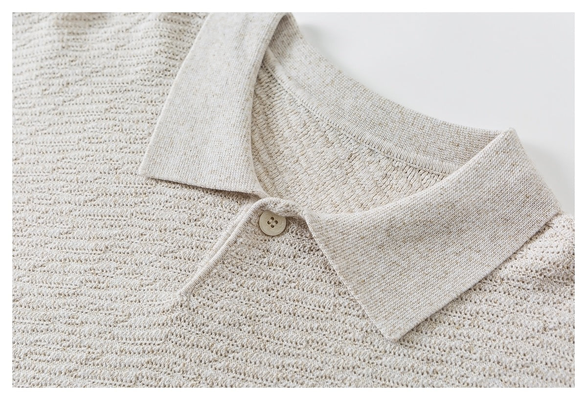 Close-up of a cream textured knit top with a pointed collar and single button.