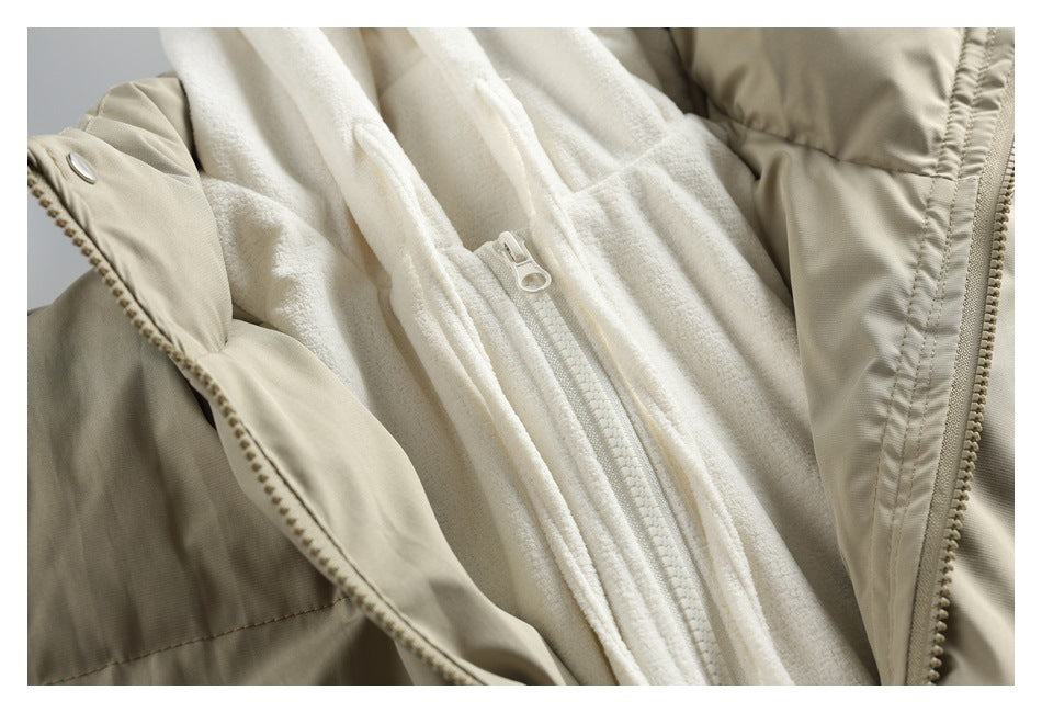 Close-up of a beige jacket opened to show a white fleece lining and inner zipper.