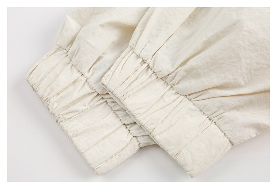 Close-up of gathered, elasticized ivory fabric edges.