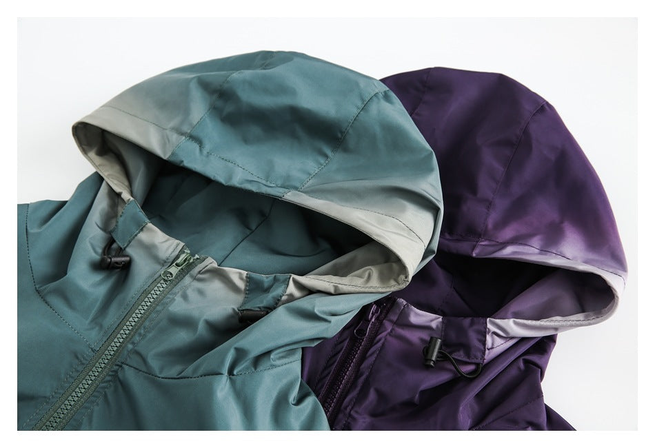 Close-up of teal and deep purple hooded jackets, showing their lined hoods, front zippers, and drawcord toggles.