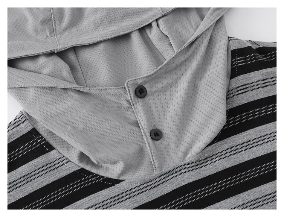 Close-up of a light gray buttoned collar and placket against a black and gray striped shirt.